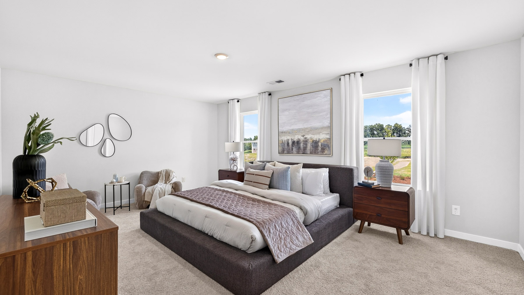 Primary carpeted bedroom with windows