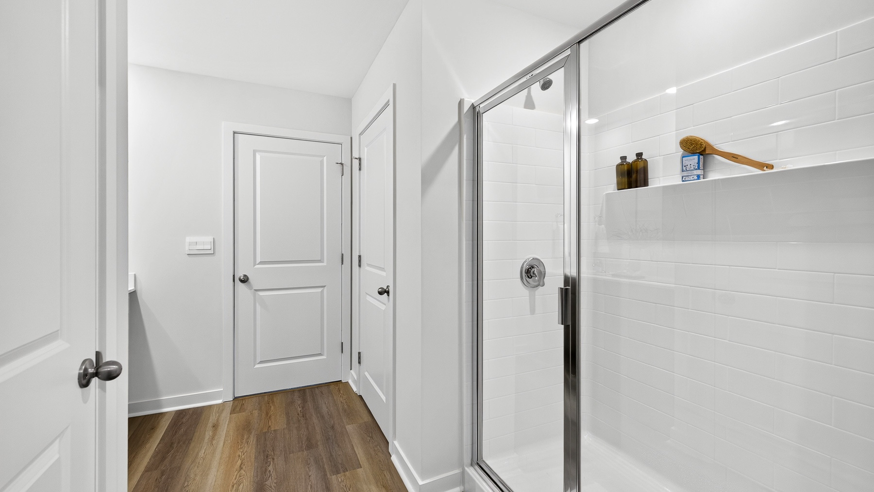 Primary bathroom with double sinks and standing glass shower