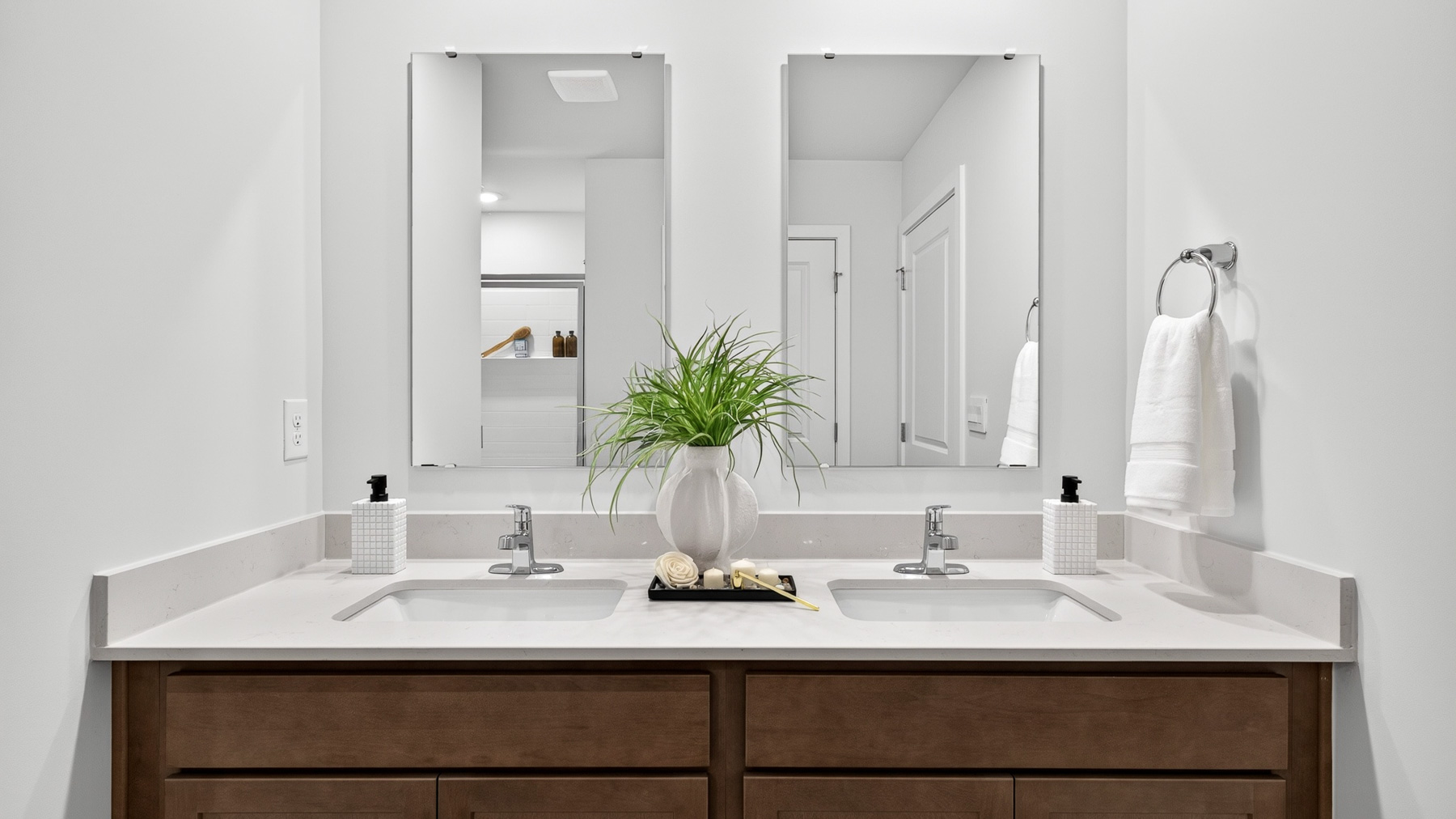 Primary bathroom with double sinks and standing glass shower