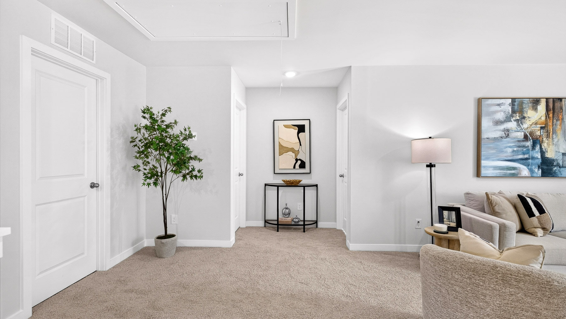 Upstairs carpeted living area with windows