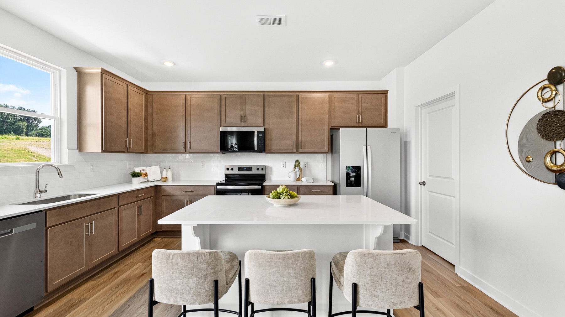 Kitchen and island with stainless steel appliances