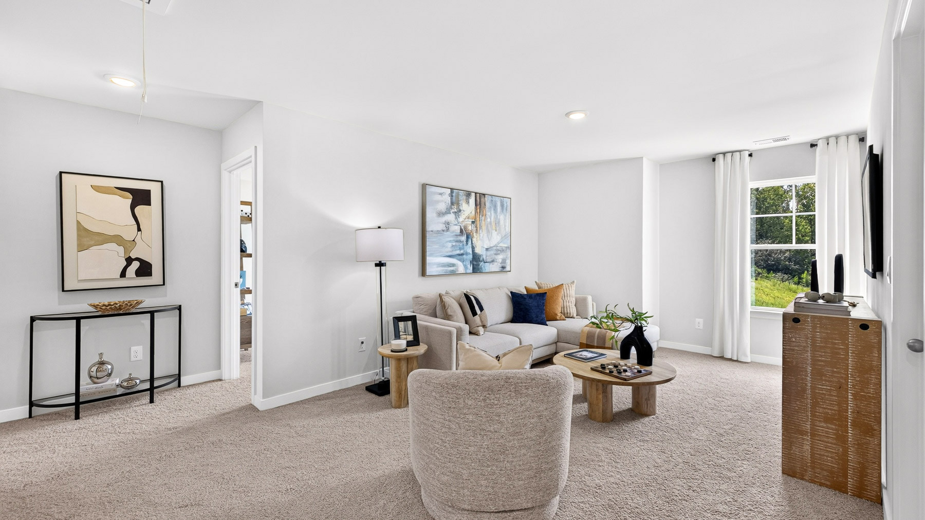 Upstairs carpeted living area with windows