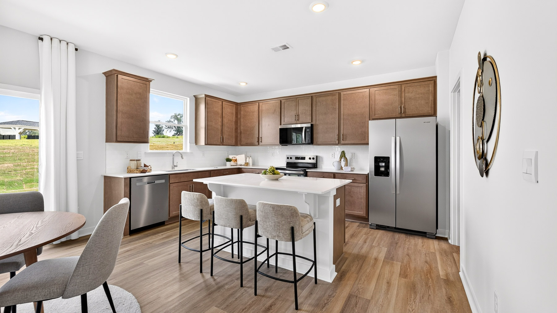 Kitchen and island with stainless steel appliances