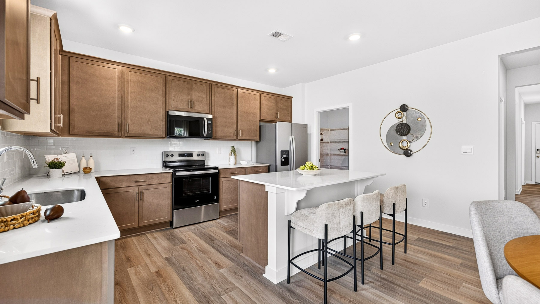 Kitchen and island with stainless steel appliances