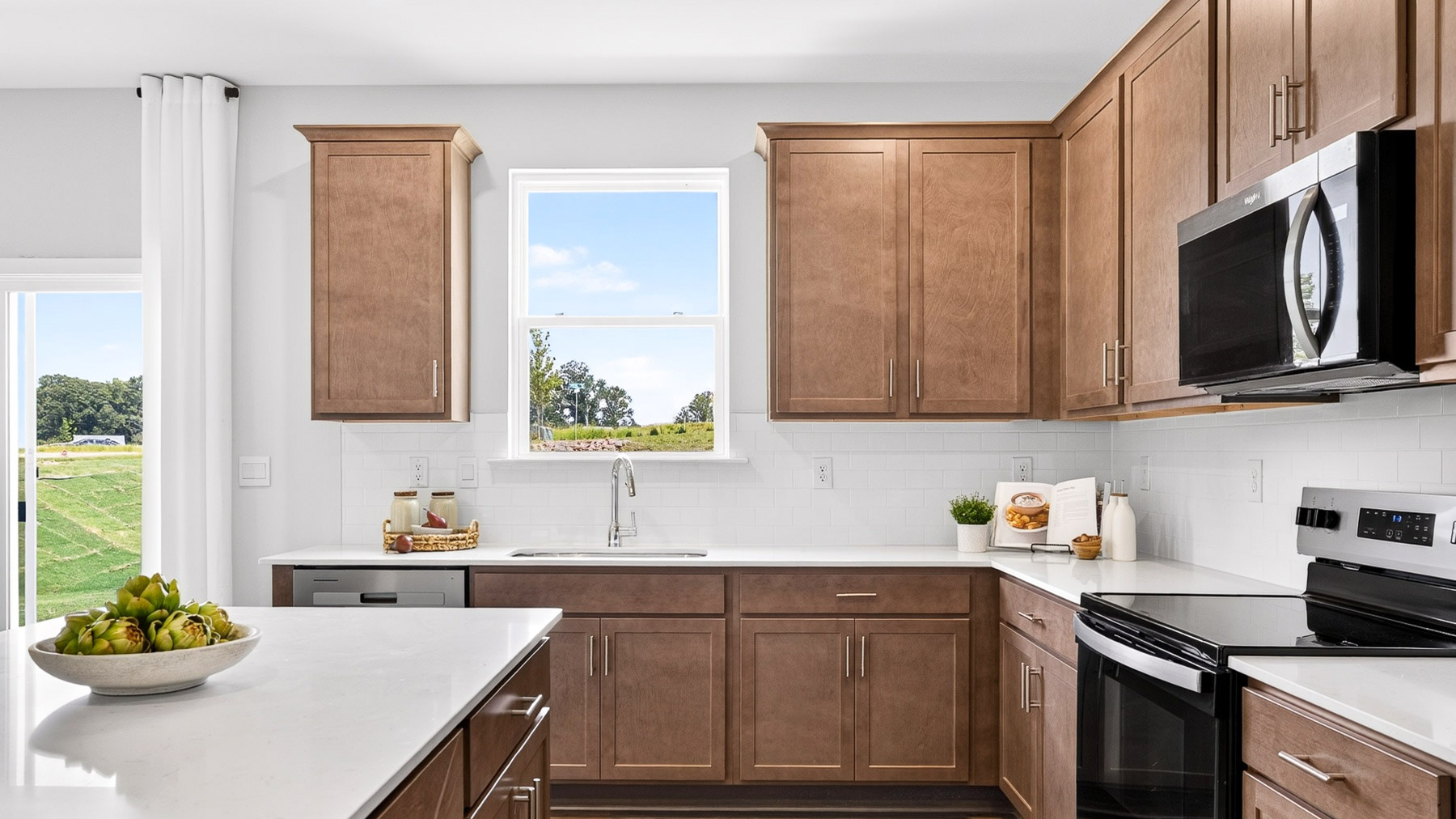 Kitchen and island with stainless steel appliances