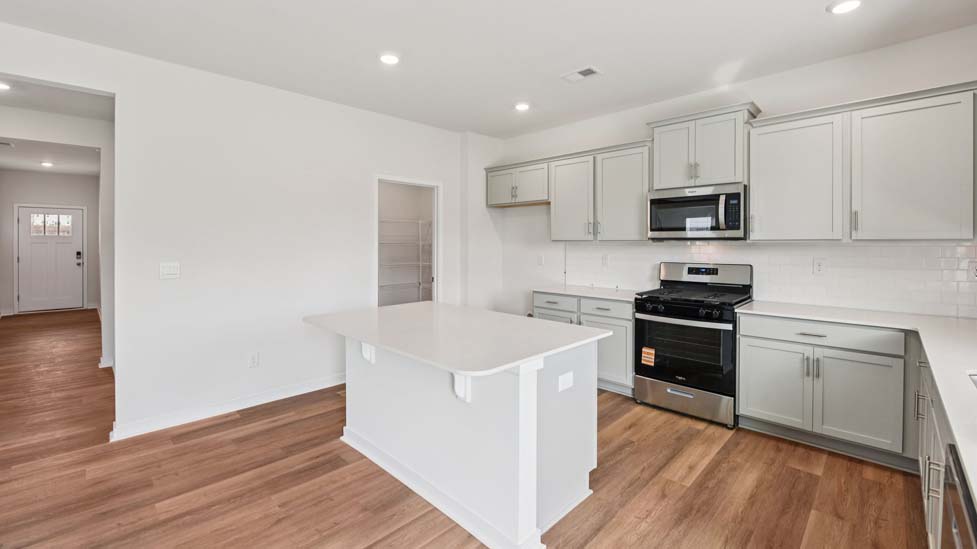Kitchen and island with stainless steel appliances