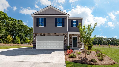 Brandon Creek Robie Model Front exterior with brown and beige stone, dark grey siding, and two car garage. New Home in Charlotte, North Carolina