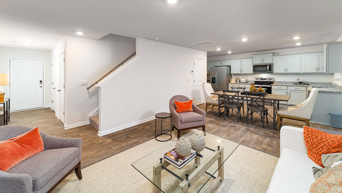 Open living room by kitchen and stairs