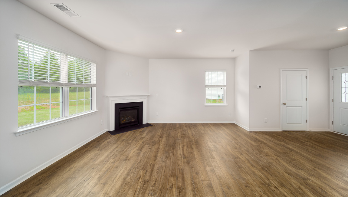 Spacious family room with large windows and fireplace