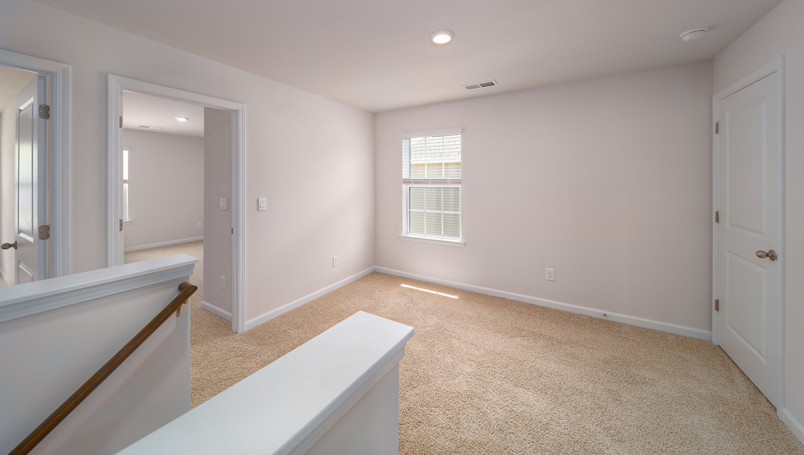 Carpeted loft space atop stairs