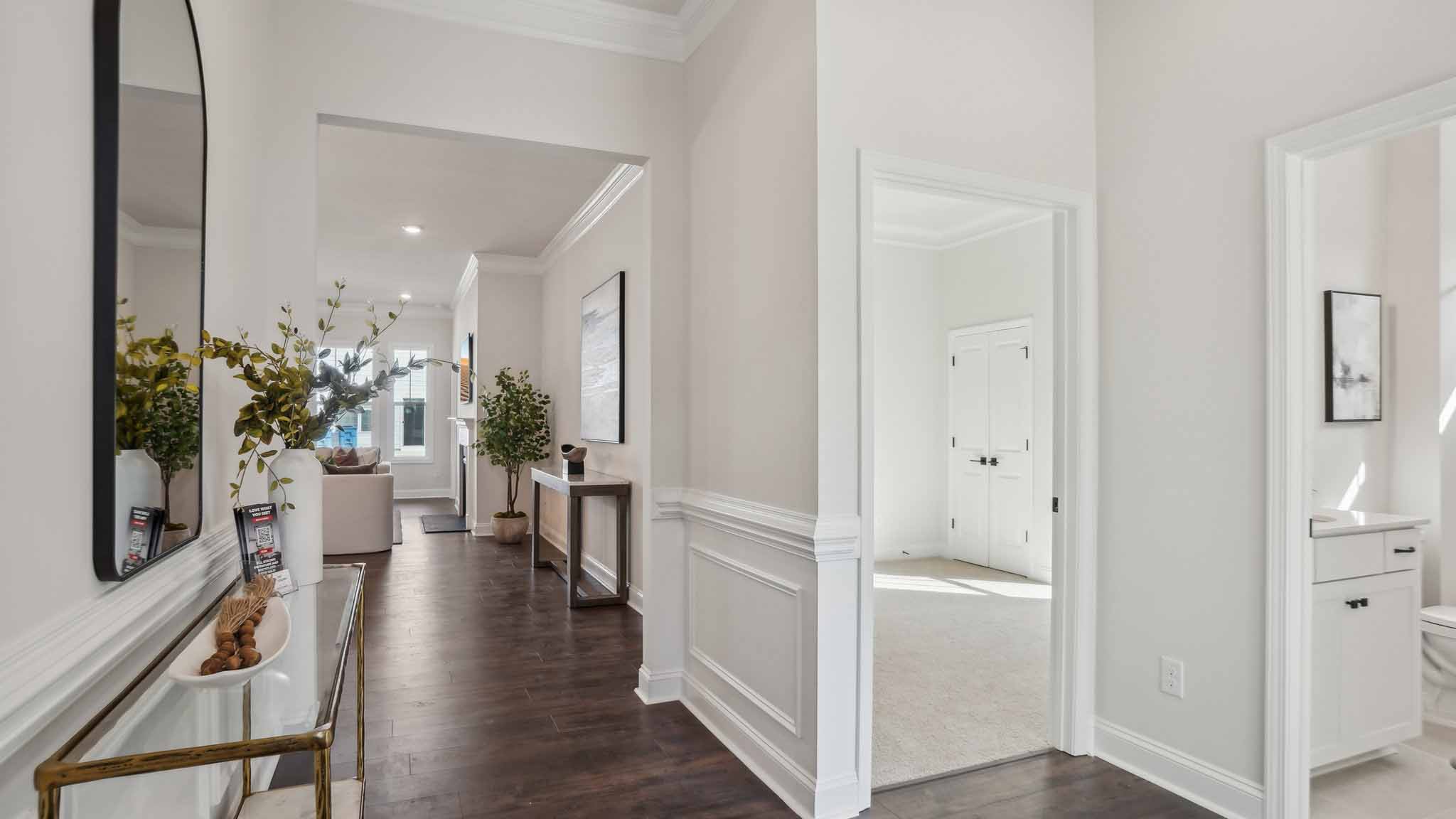 Welcoming foyer with staircase view and wood floors