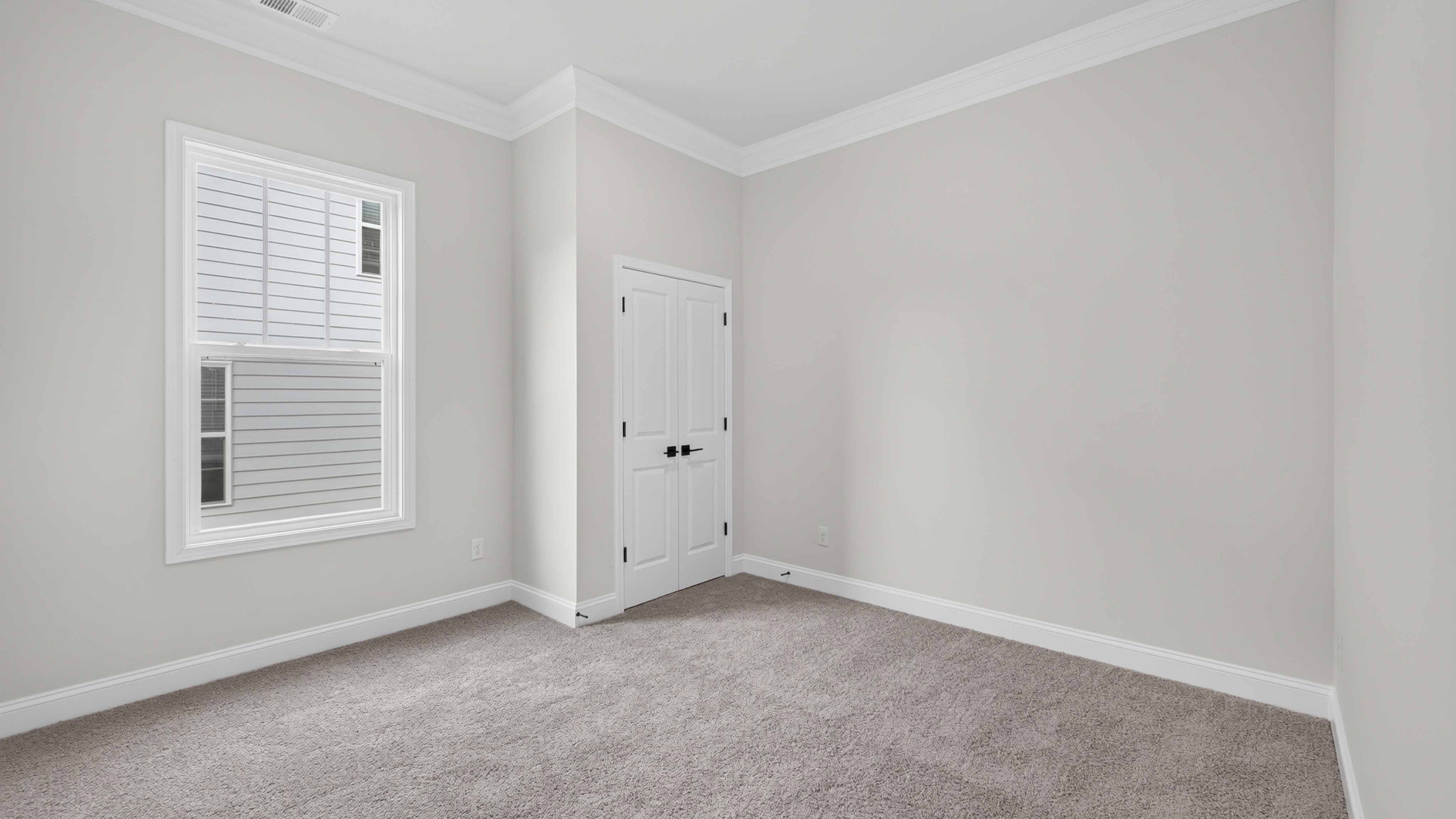 Carpeted bedroom three large windows