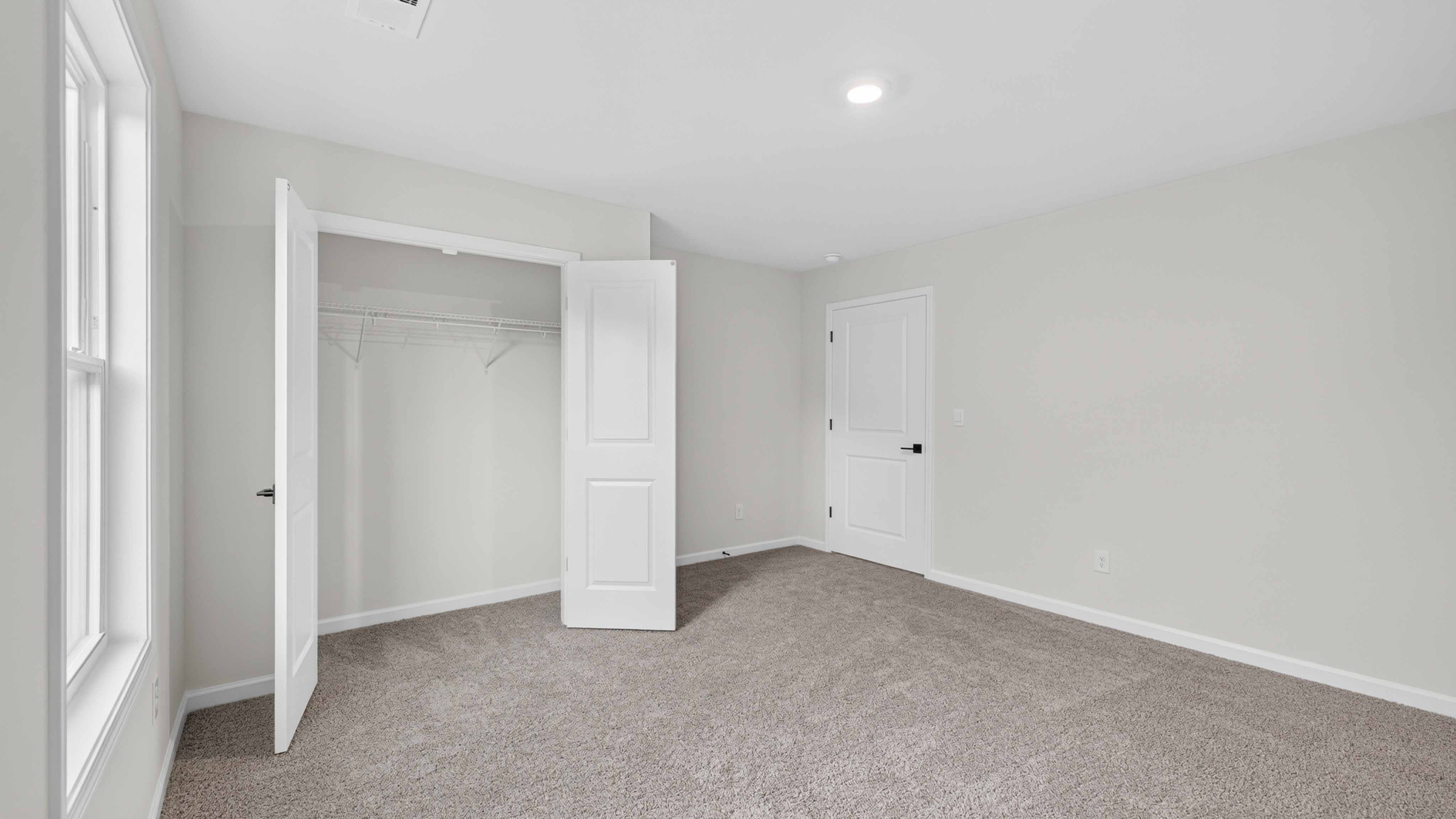 Carpeted bedroom three large windows