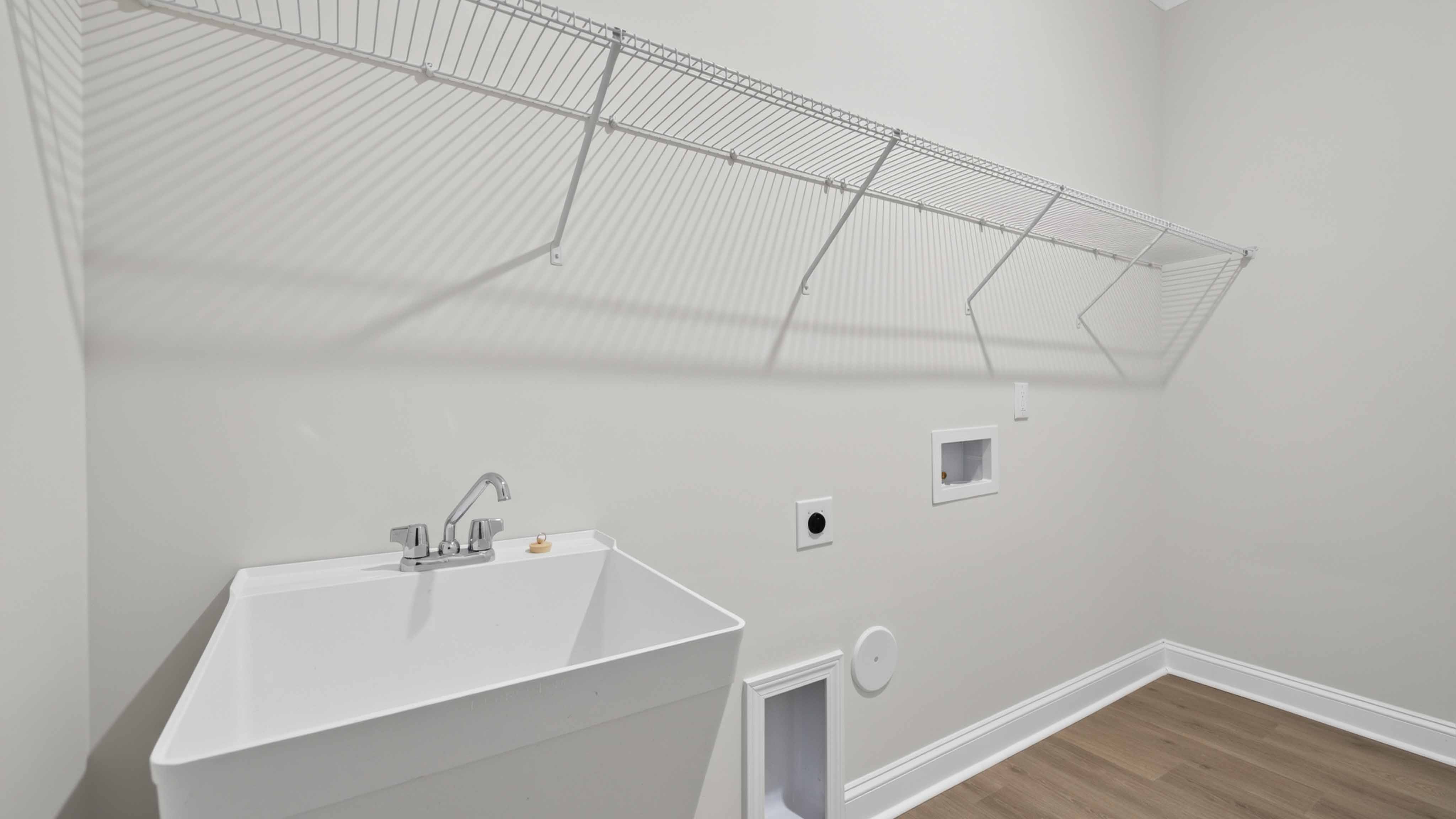 Laundry room with built in racks above machines