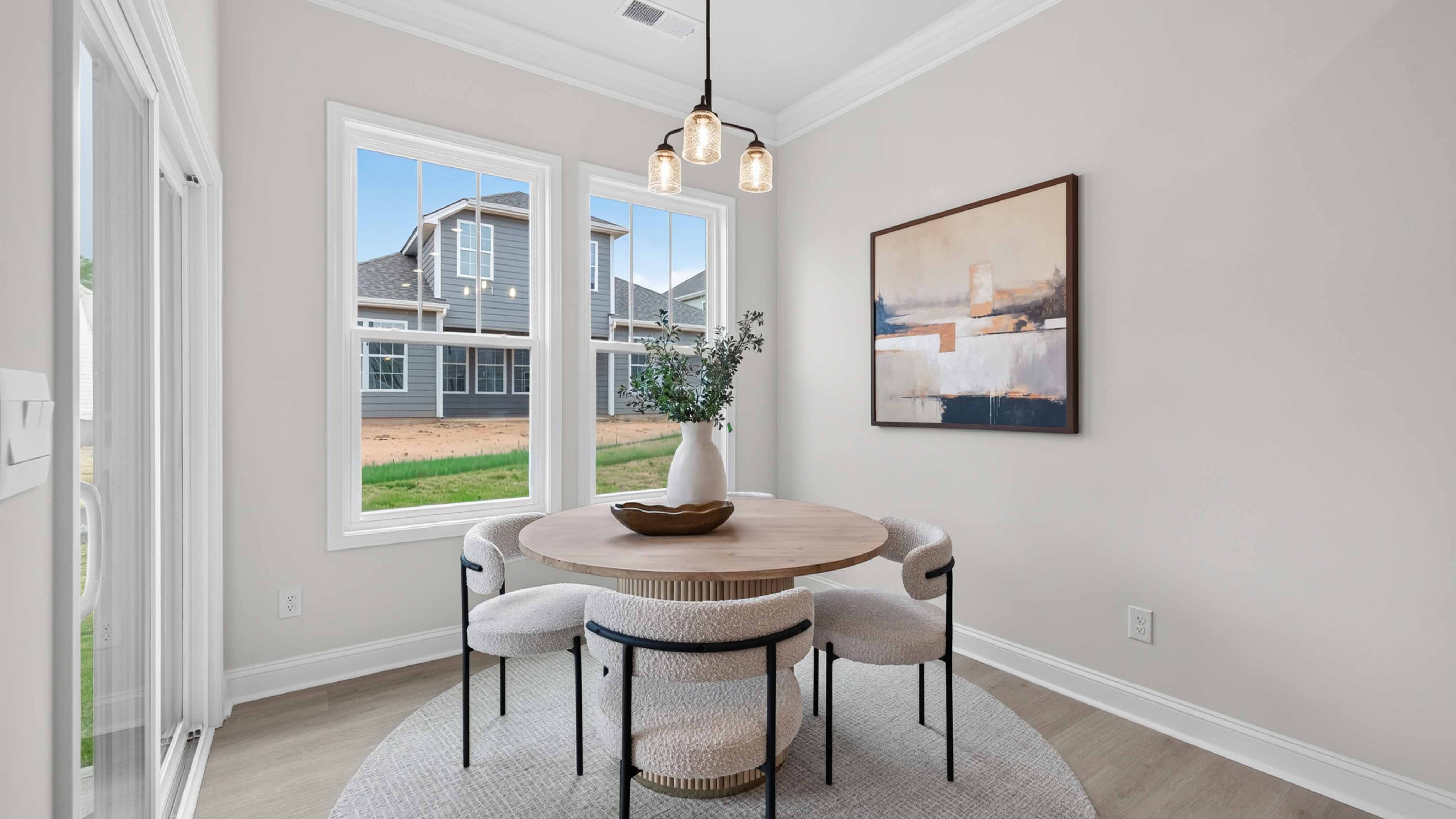 Breakfast area with wood floors, and surrounded by large windows