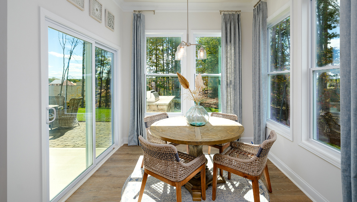 Breakfast area with wood floors, and surrounded by large windows