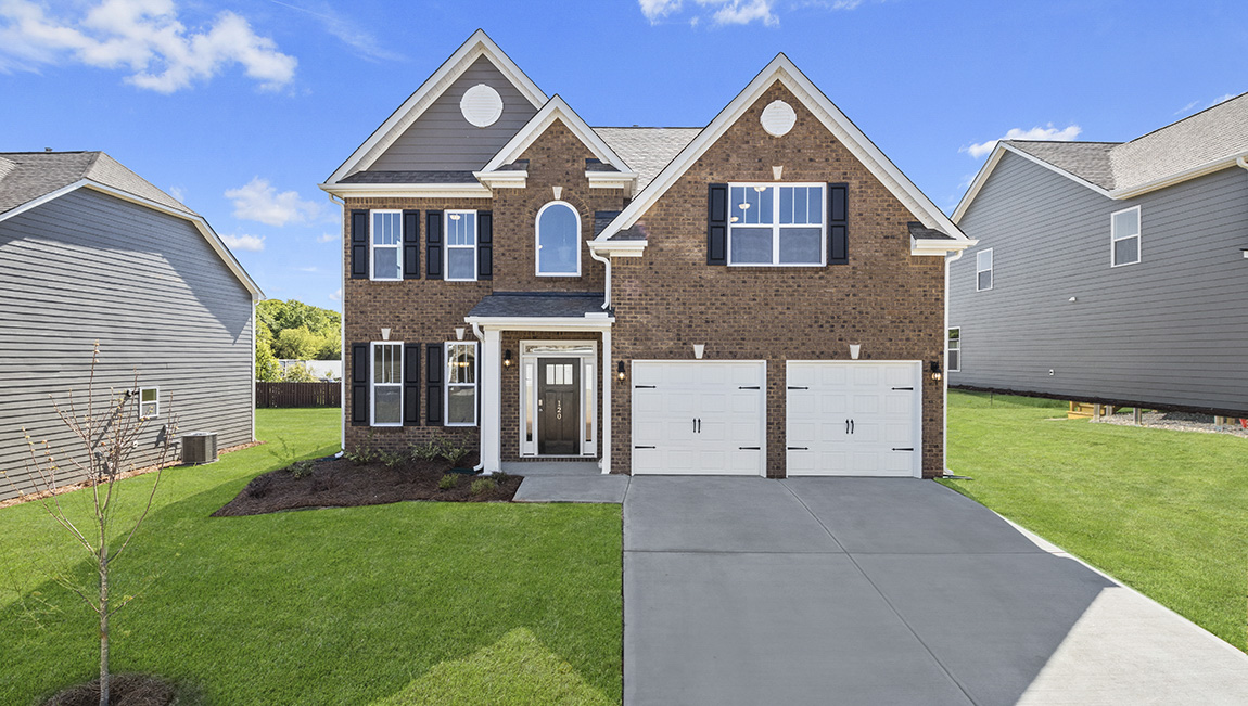 Fleetwood front exterior with brick and siding and two car garage