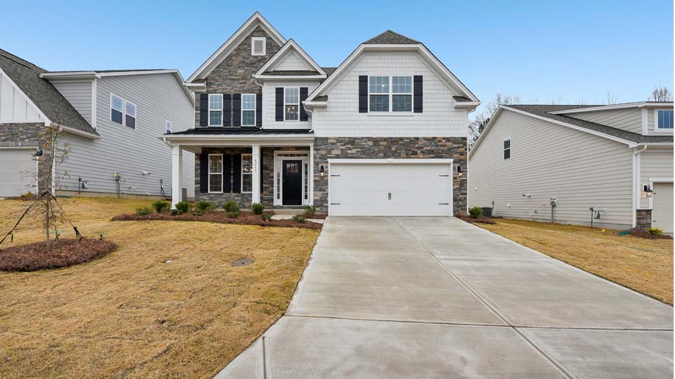 Fleetwood front exterior with brick and siding and two car garage