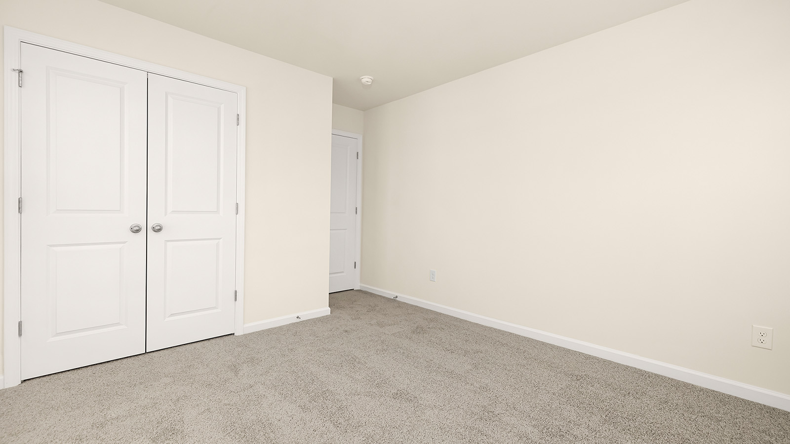 Carpeted bedroom with medium window