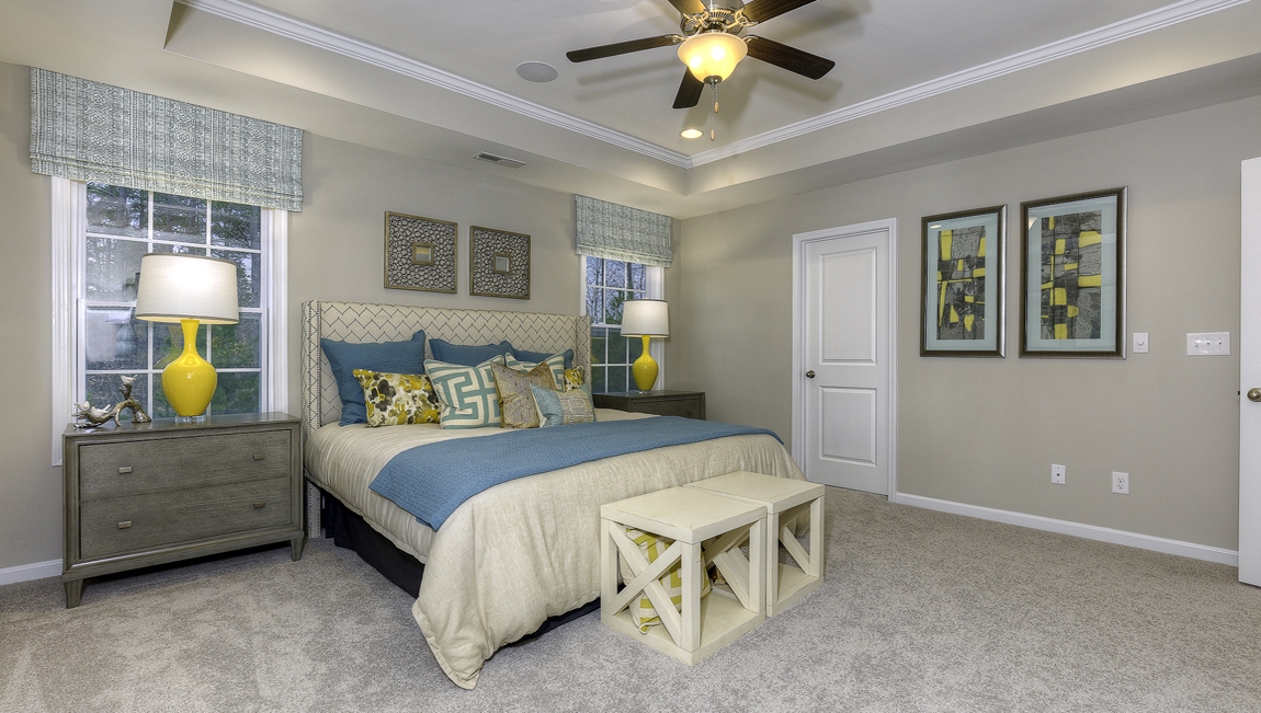 Primary suite carpeted with two windows