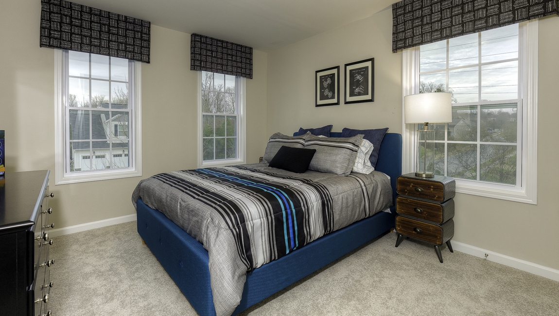 Carpeted bedroom with 3 windows