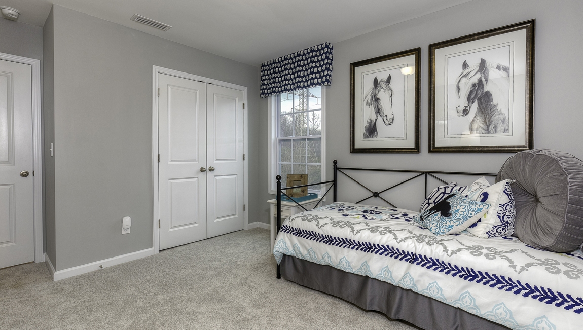 Carpeted bedroom with large window