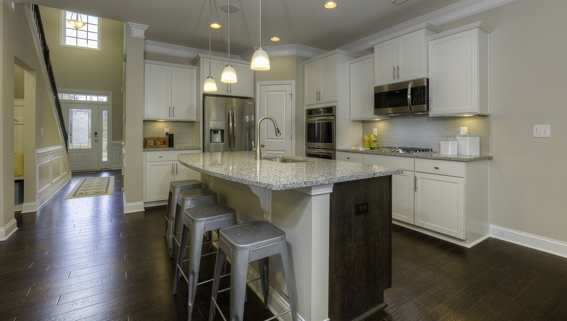 Kitchen and island with white cabinets