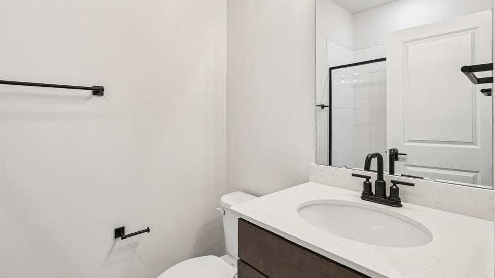Bathroom with white cabinets and a shower/tub combination