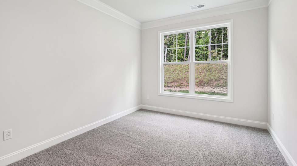 Carpeted bedroom with small window