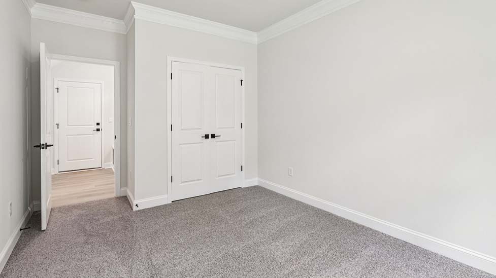 Carpeted bedroom with small window