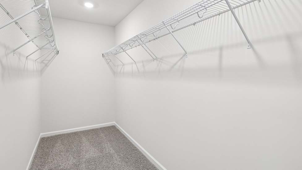 Primary bedroom walk in closet