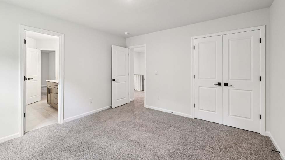 Carpeted bedroom with small window