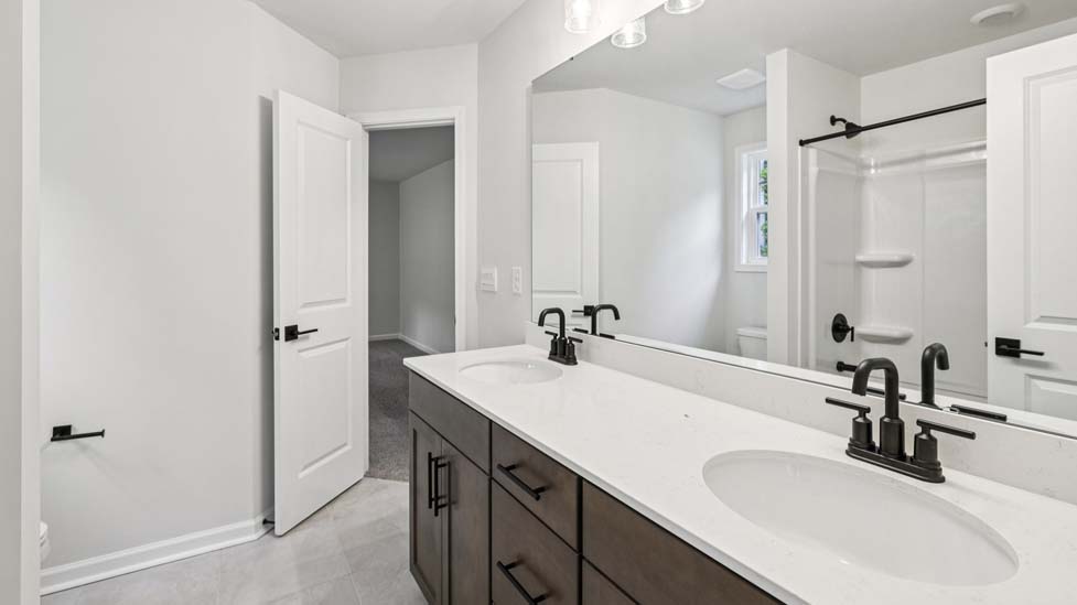 Bathroom with white cabinets and a shower/tub combination