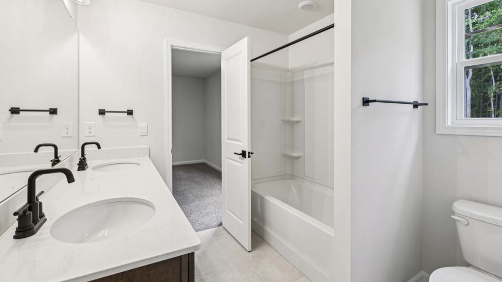 Bathroom with white cabinets and a shower/tub combination