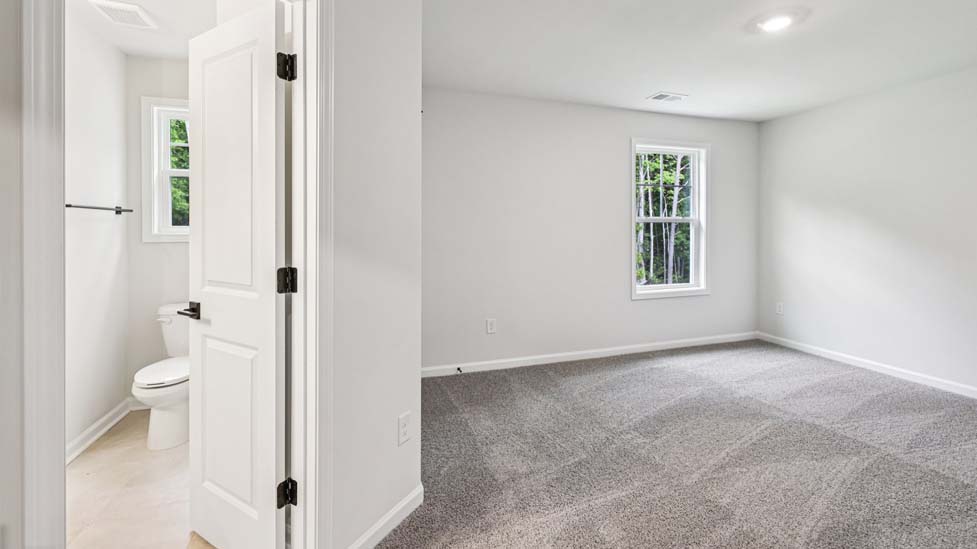 Carpeted bedroom with small window