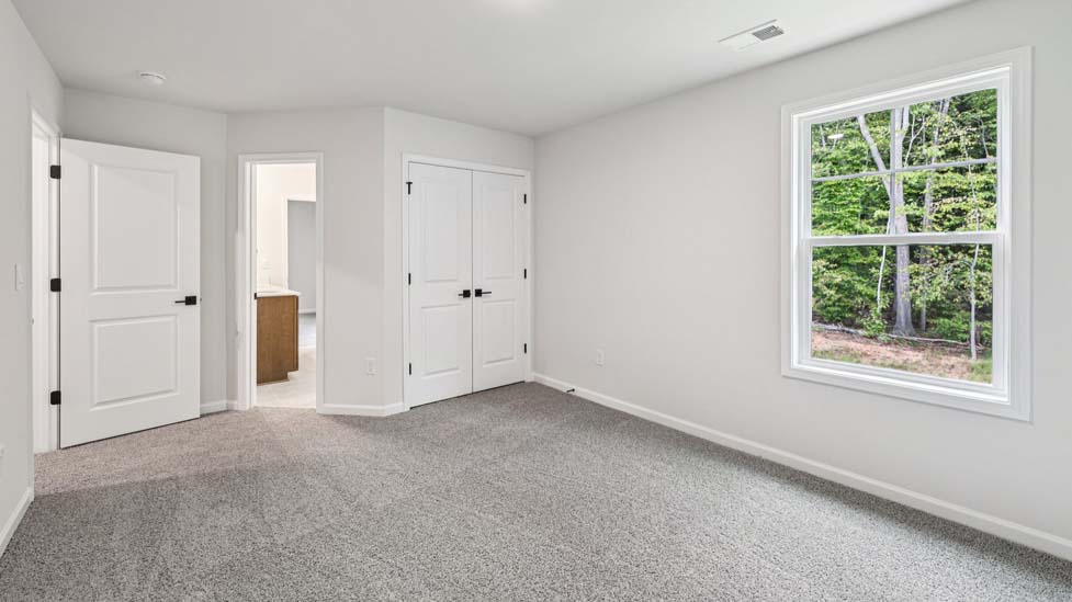 Carpeted bedroom with small window