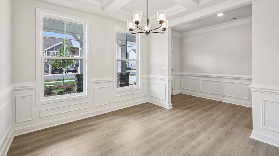 Dining room area with large windows and wood floors