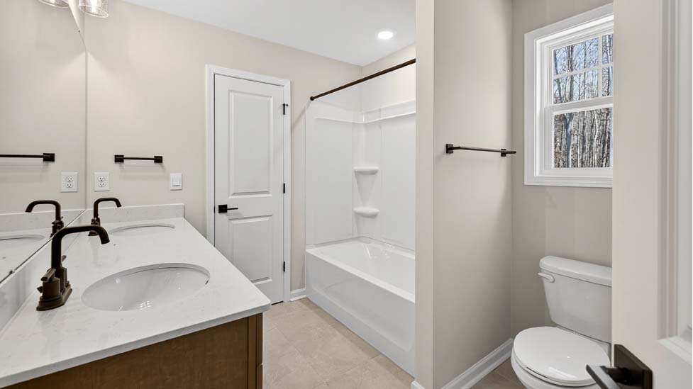 Bathroom with white cabinets and a shower/tub combination