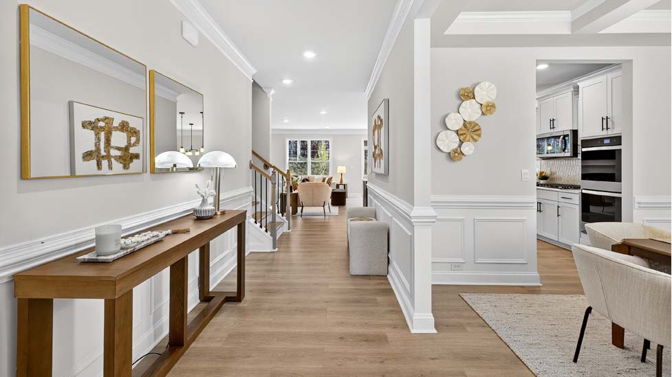 Welcoming foyer with staircase view and wood floors
