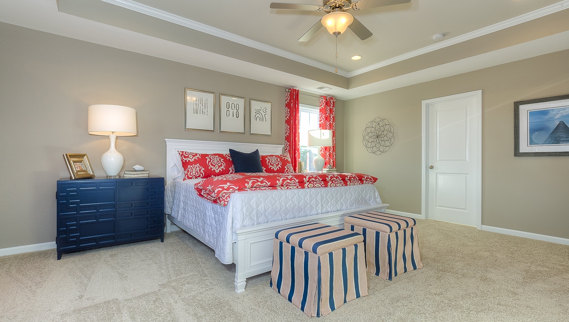 Primary bedroom with carpet and large windows