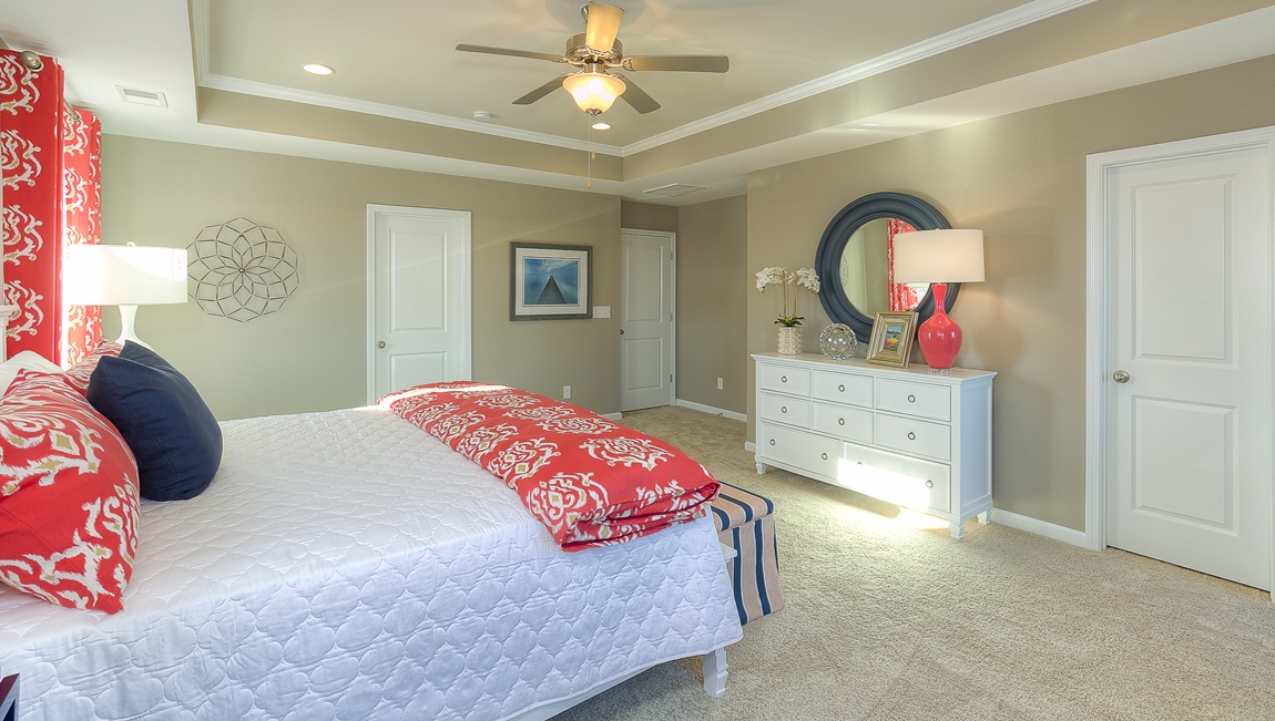 Primary bedroom with carpet and large windows
