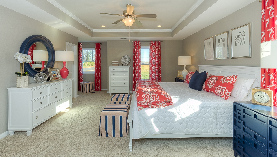 Primary bedroom with carpet and large windows