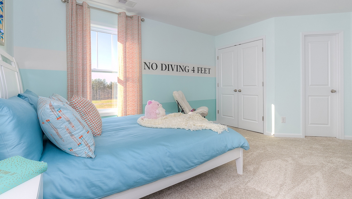 Carpeted bedroom with small window