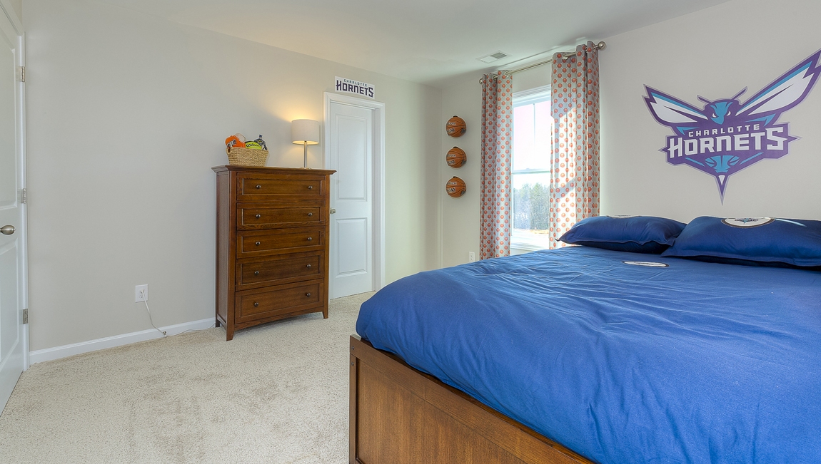 Carpeted bedroom with small window