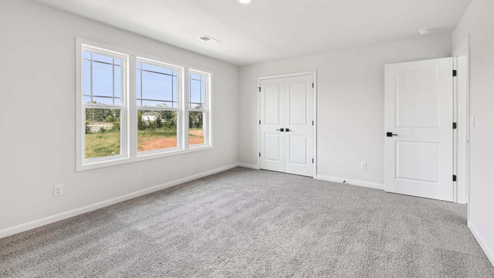 Carpeted bedroom with window