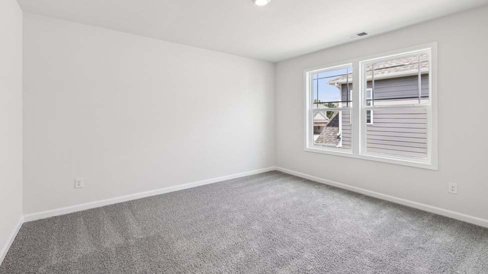 Carpeted bedroom with window