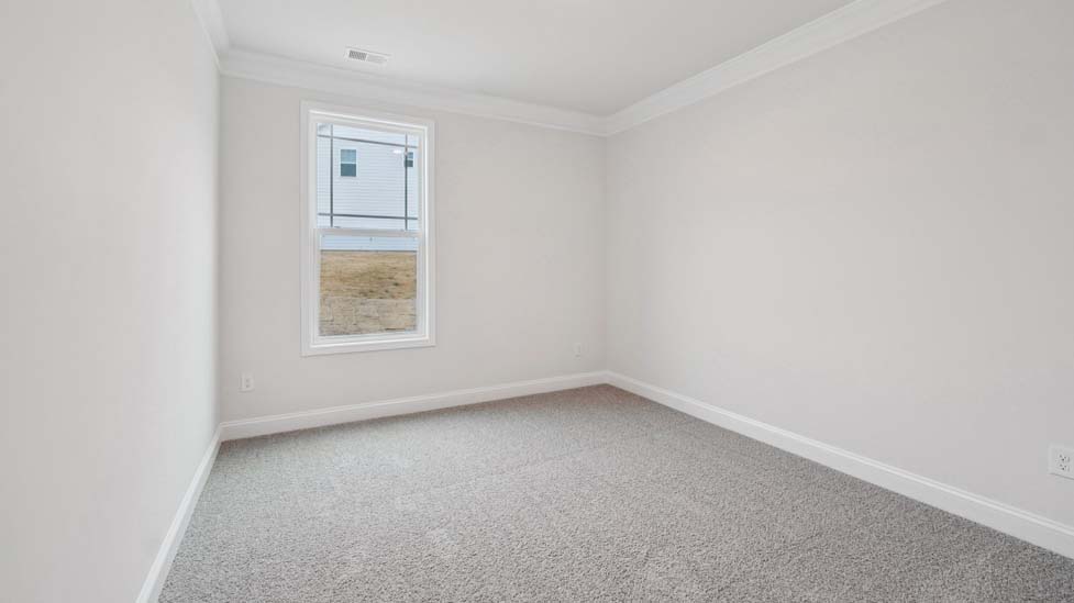 Carpeted bedroom with window