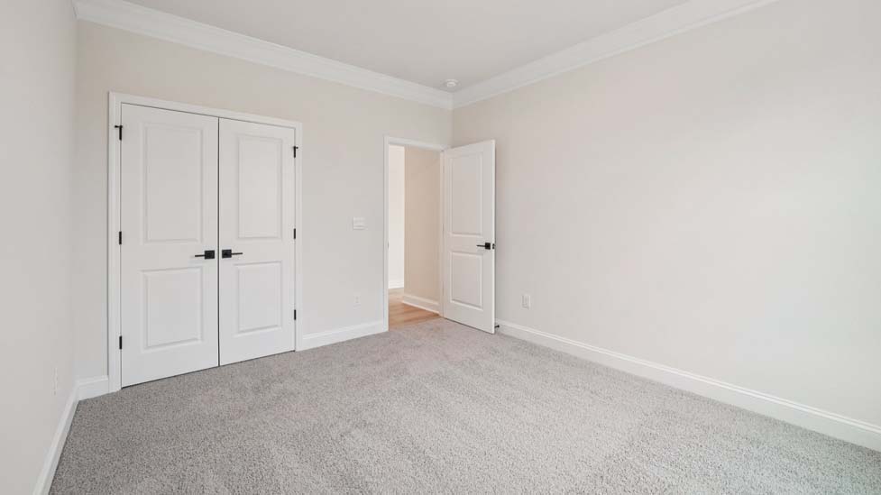 Carpeted bedroom with window