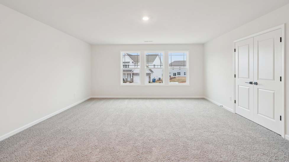 Carpeted bedroom with window