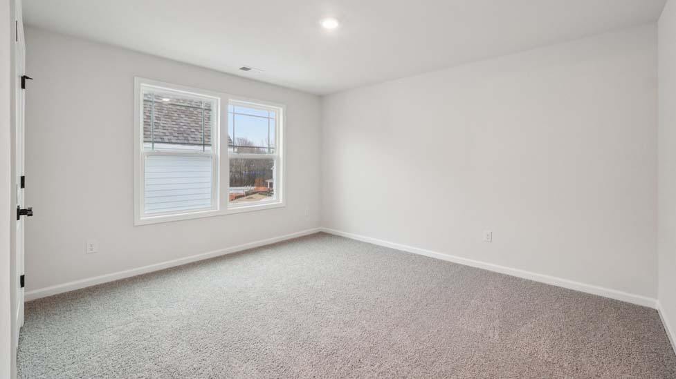 Carpeted bedroom with window